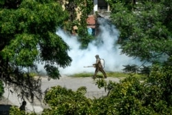 A worker sprays disinfectant in a residential area during a government-imposed nationwide lockdown as a preventive measure against the COVID-19 coronavirus, in Islamabad, Pakistan.