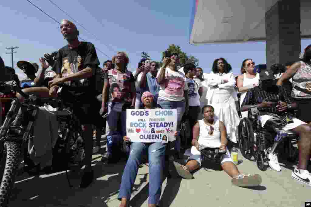 Local resident watch the memorial service on a big screen TV down the street from the Greater Grace Temple where the funeral for legendary singer Aretha Franklin takes place in Detroit, Aug. 31, 2018.