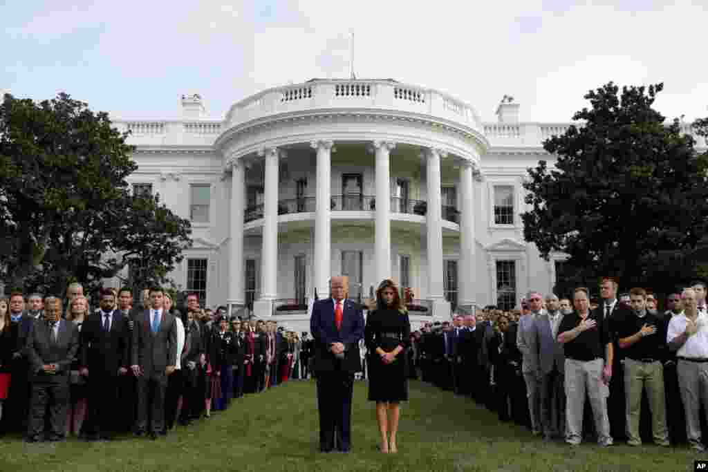 President Donald Trump and first lady Melania Trump participate in a moment of silence honoring the victims of the Sept. 11 terrorist attacks, on the South Lawn of the White House, Sept. 11, 2019, in Washington.