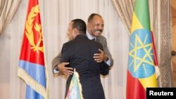 Ethiopian Prime Minister Abiy Ahmed and Eritrean President Isaias Afwerk embrace at the declaration signing in Asmara, Eritrea, July 9, 2018, in this photo obtained from social media. (Ghideon Musa Aron Visafric)