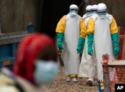 FILE - Health workers begin their shift at an Ebola treatment center in Beni, Democratic Republic of Congo, July 16, 2019.