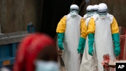 FILE - Health workers begin their shift at an Ebola treatment center in Beni, Democratic Republic of Congo, July 16, 2019. 