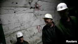 FILE - Miners walk in underground tunnel in Trepca mines, Mitrovica, Nov. 2008.