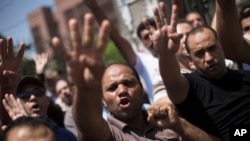 Supporters of Egypt's ousted President Mohammed Morsi chant slogans against the Egyptian Army during a march near Al Nour mosque in Abassia district in Cairo, Egypt, Aug. 23, 2013. 