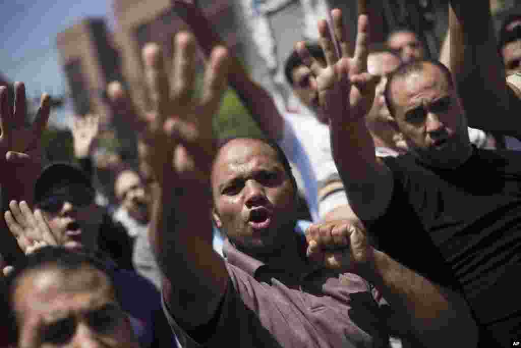 Supporters of Egypt's ousted President Mohammed Morsi chant slogans against the Egyptian Army during a march near Al Nour mosque in Abassia district in Cairo, Egypt, Aug. 23, 2013. 