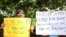 Sri Lankan civil rights activists hold placards during a demonstration outside the official residence of ousted Prime Minister Ranil Wickremesinghe in Colombo, Sri Lanka, Nov 4, 2018. 