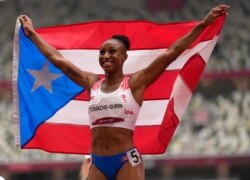Jasmine Camacho-Quinn, of Puerto Rico celebrates after winning the gold in the women's 100-meters hurdles final at the 2020 Summer Olympics, Aug. 2, 2021, in Tokyo, Japan.