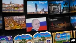 A vendor sells refrigerator magnets showing a picture of Russian President Vladimir Putin, on main pedestrian street in downtown Belgrade, Serbia, Jan. 16, 2023. 