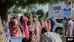 FILE - Women queue to cast their votes during a constitutional referendum at a polling station in N'Djamena, Chad, Dec. 17, 2023. Activists complain that women constitute just over one-third of the candidates in legislative, local and district elections scheduled for next month.
