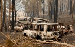 A cluster of burnt out cars sit at a property at Rainbow Flat, Australia, Nov. 11, 2019.
