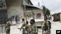 Somali government soldiers patrol in Mogadishu's Bakara market, August 8, 2011