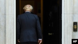 Britain's Prime Minister Boris Johnson walks back into 10 Downing Street after greeting US Vice President Mike Pence in London, Sept. 5, 2019. 