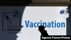 A man walks in front of a vaccination center in the city of Munich, Germany, Nov. 11, 2021, amid a surge of infections during the ongoing COVID-19 pandemic. 