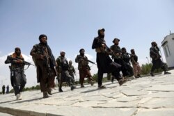 FILE - Taliban fighters patrol in Kabul, Afghanistan, Aug. 19, 2021.