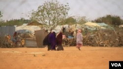 FILE - Refugees are seen walking at Dadaab refugee camp, in Kenya, Sept. 19, 2020.