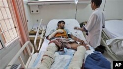 A Yemeni doctor checks on a tribesman loyal to Sheik Sadeq al-Ahmar, the head of the powerful Hashid tribe, who was injured Tuesday in clashes with Yemeni security forces, in a hospital in Sanaa, Yemen, May 25, 2011