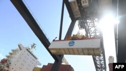 Shipping containers are offloaded from a cargo ship at Port Everglades, June 24, 2016, in Fort Lauderdale, Florida. 