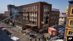 FILE—Medics and emergency works at the scene of a deadly blaze in Johannesburg, August 31, 2023. 