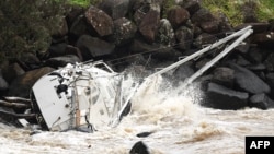 A damaged yacht that was swept away by the waves rests at Point Danger on the southern end of Australia's Gold Coast on March 7, 2025. 