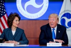 FILE - President Donald Trump, accompanied by Transportation Secretary Elaine Chao, left, speaks at a roundtable on infrastructure at the Department of Transportation, June 9, 2017, in Washington.