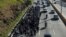 FILE - Salvadorans take part in a new caravan of migrants, heading to the United States, as they leave San Salvador, El Salvador, Jan. 16, 2019. 