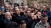 Christian worshippers hold a cross as they walk along the Via Dolorosa towards the Church of the Holy Sepulchre, traditionally believed by many to be the site of the crucifixion of Jesus Christ, during the Good Friday procession in Jerusalem's Old City.