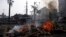 The remains of tents burn outside Rabaah al-Adawiya mosque, where supporters of Egypt's ousted President Morsi set up a protest camp, Aug. 15, 2013.