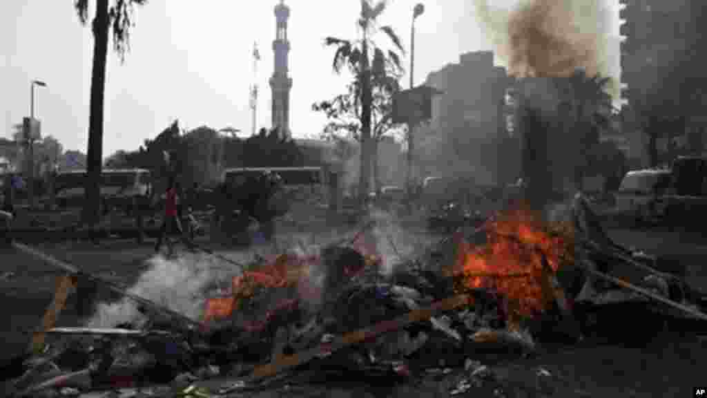 The remains of tents burn outside Rabaah al-Adawiya mosque, where supporters of Egypt's ousted President Morsi had a protest camp, Aug. 15, 2013.