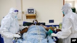 Medical staff wearing protective equipment attend to patients affected by the COVID-19, at a hospital in Machakos, Kenya, June 17, 2021.