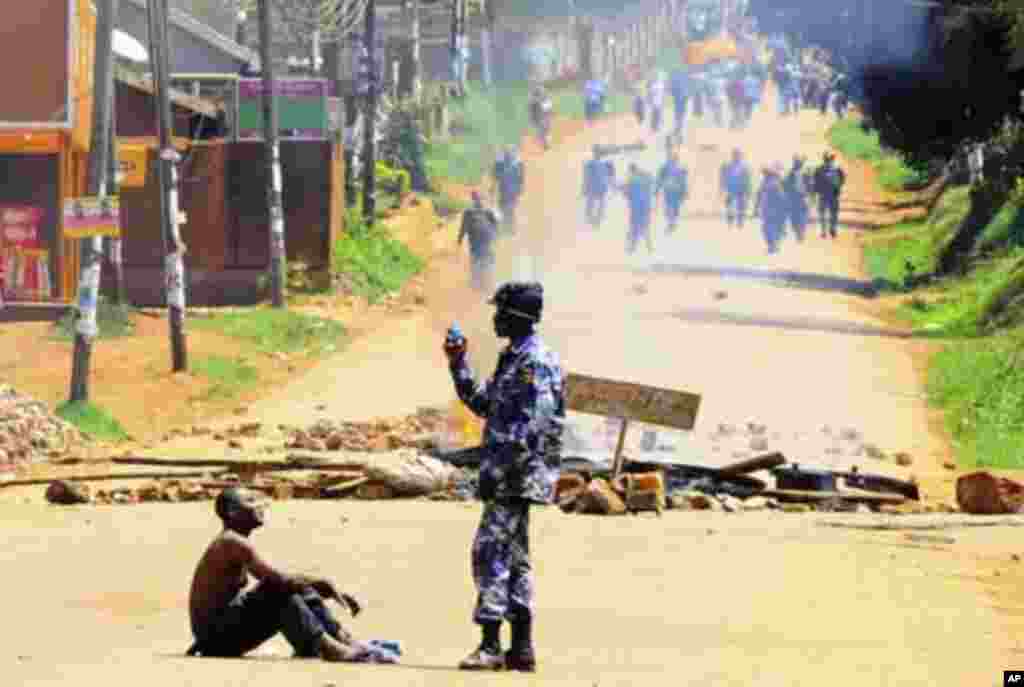 A policeman arrests a supporter of Uganda's Forum for Democratic Change (FDC) leader Kizza Besigye during a protest in Kireka suburb of the capital Kampala, April 18, 2011. Ugandan opposition leader Besigye was charged in court on Monday with engaging in