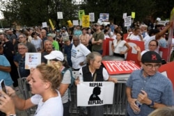 Demonstrators gather near the U.S. House Republican Member Retreat where President Donald Trump is speaking, in Baltimore, Sept. 12, 2019.