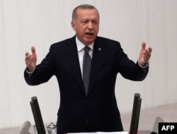 FILE - Turkish President Recep Tayyip Erdogan gestures as he delivers a speech during the opening of the third legislative session of the Turkish parliament’s 27th term, at the Grand National Assembly of Turkey in Ankara, Oct. 1, 2019.