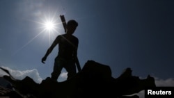 A Palestinian man inspects a destroyed Islamic Jihad military base after it was targeted by an Israeli warplane, at the southern Gaza Strip, May 30, 2018.