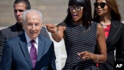 L'ancien président israélien et Nobel de la paix Shimon Peres, aux côtés de la top model britannique Naomi Campbell, lors de la Journée de la Femme, à Tel Aviv le 8 mars 2016.