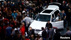 People visit the booth of German carmaker BMW at the Frankfurt Motor Show (IAA) in Frankfurt, Germany Sept. 19, 2015. 