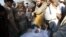 Villagers look at the body of health worker Hilal Khan, who was killed by gunmen in Wahidgari, outside of Peshawar, Pakistan, Dec. 20, 2012. 
