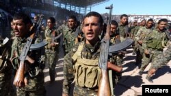 Syrian Democratic Forces celebrate the first anniversary of the Raqqa province liberation from the Islamic State group in Raqqa, Syria, Oct. 27, 2018.