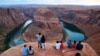 FILE - Visitors view the dramatic bend in the Colorado River at the popular Horseshoe Bend at the Glen Canyon National Recreation Area, in Page, Arizona, Sept. 9, 2011. 