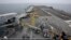 FILE - French sailors work on the flight deck of the French Navy aircraft carrier Charles de Gaulle in the Persian Gulf, March 17, 2015. 