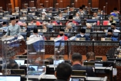 Malaysia's Finance Minister Tengku Zafrul presents the 2021 budget at the parliament house in Kuala Lumpur, Nov. 6, 2020. (Malaysia Information Department/Famer Roheni/Handout via Reuters)