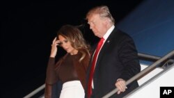 President Trump and first lady Melania Trump walk from Air Force One, Nov. 29, 2018, as they arrive in Buenos Aires, Argentina.