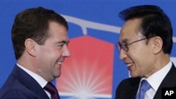 Russian President Dmitry Medvedev, left, and South Korean President Lee Myung-bak shake hands before their press conference in Seoul, South Korea. Medevev is on an official visit to South Korea. Twenty world leaders, including Medvedev, will come togethe