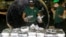 A member of the Philippine Drug Enforcement Agency, PDEA, collects packs of Methamphetamine Hydrochloride also known as "Shabu" which they found hidden inside a steel cylinder in one of the biggest drug hauls in Manila, Philippines, on Aug. 7, 2018. 