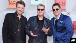 FILE - Joe Don Rooney, from left, Gary LeVox, and Jay DeMarcus, of Rascal Flatts, arrive at the 51st annual Academy of Country Music Awards in Las Vegas, April 3, 2016.