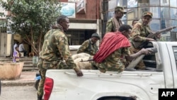 Members of the Amhara militia that sides with federal and regional forces against the northern region of Tigray ride on the back of a pick up truck in the city of Gondar, Ethiopia, Nov. 8, 2020.