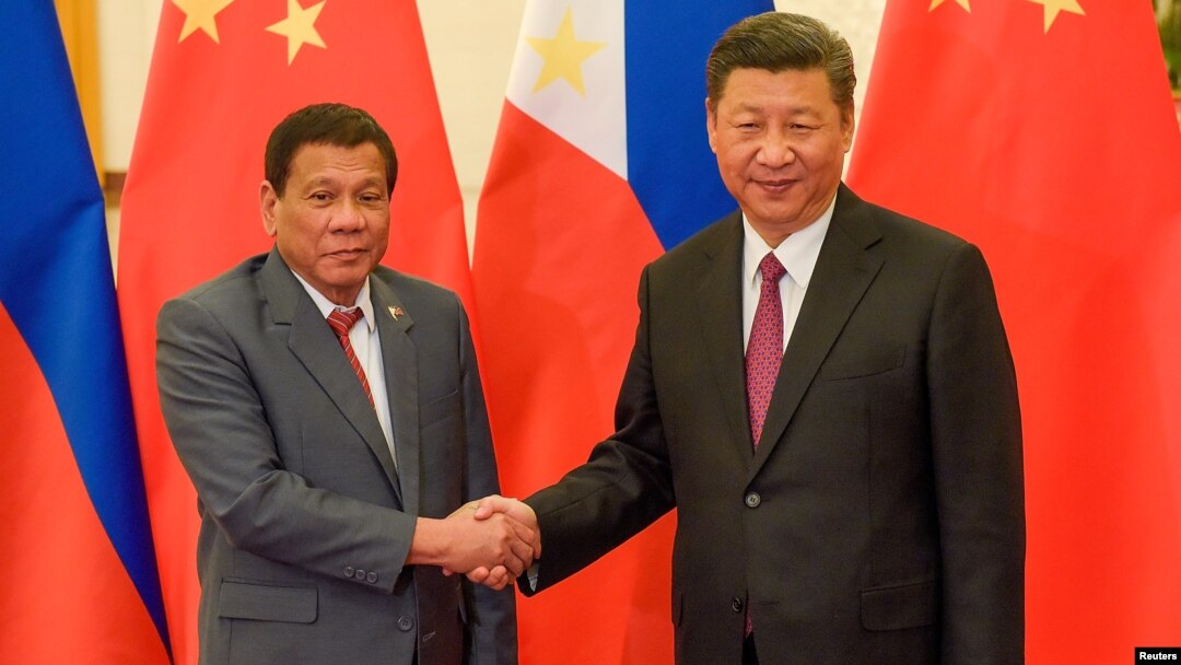 FILE - Chinese President Xi Jinping, right, shakes hands with Philippines President Rodrigo Duterte before their bilateral meeting during the Belt and Road Forum, Beijing, May 15, 2017.
