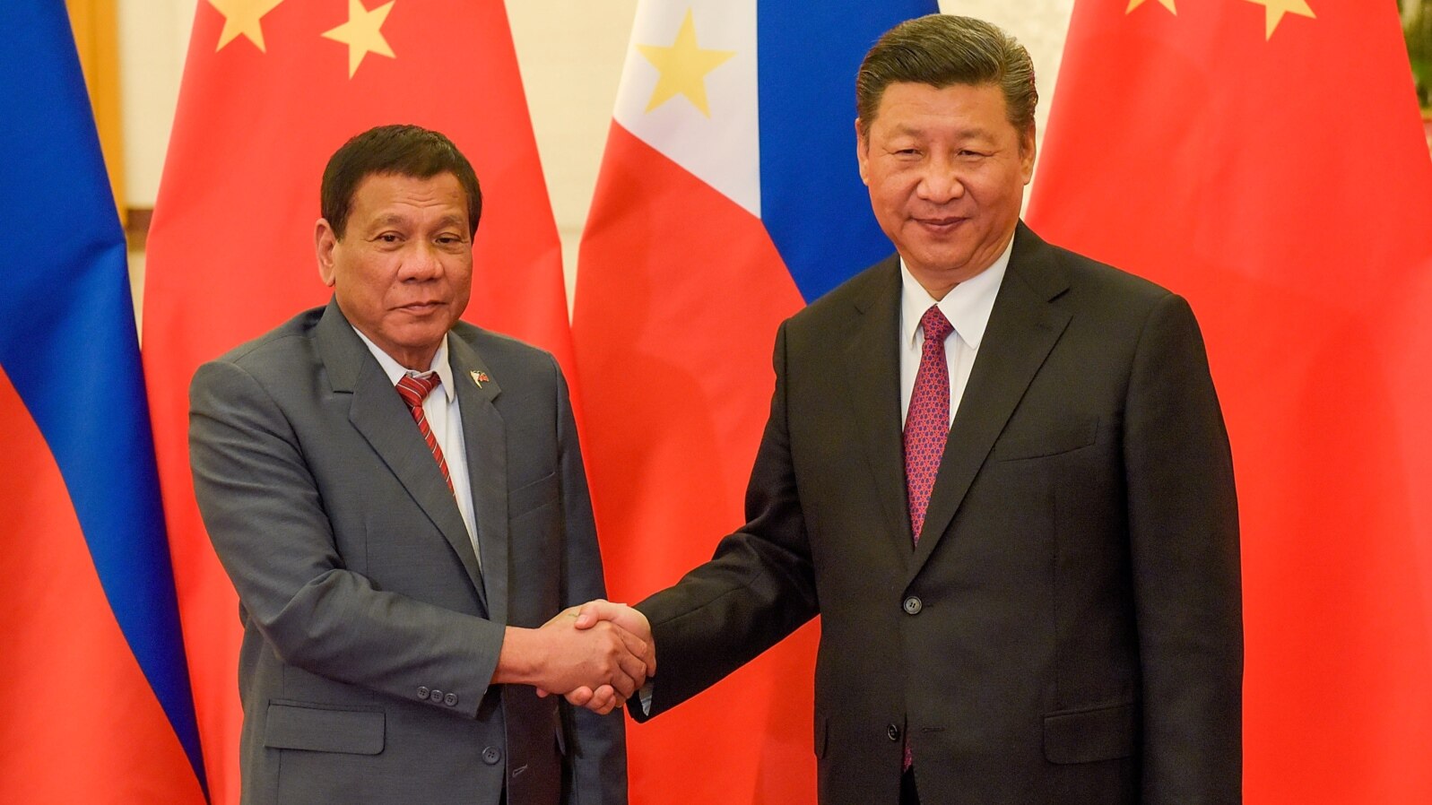 FILE - Chinese President Xi Jinping, right, shakes hands with Philippines President Rodrigo Duterte before their bilateral meeting during the Belt and Road Forum, Beijing, May 15, 2017.