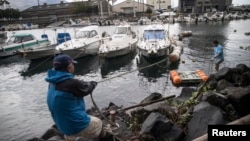 Japanese amateur fishermen prepare their boats for the possible impact of Typhoon Trami, in southern city of Kagoshima, on Kyushu island, Sept. 29, 2018.