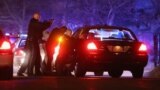 Police with guns drawn search for a suspect on April 19, 2013 in Watertown, Massachusetts.