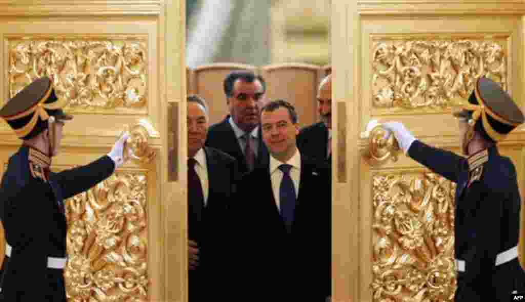 From left, Kazakh President Nursultan Nazarbayev, partly visible, Tajik President Emomali Rakhmon, Russian President Dmitry Medvedev, and Belarusian President Alexander Lukashenko, partly visible, enter a hall to attend a summit of the Collective Securi